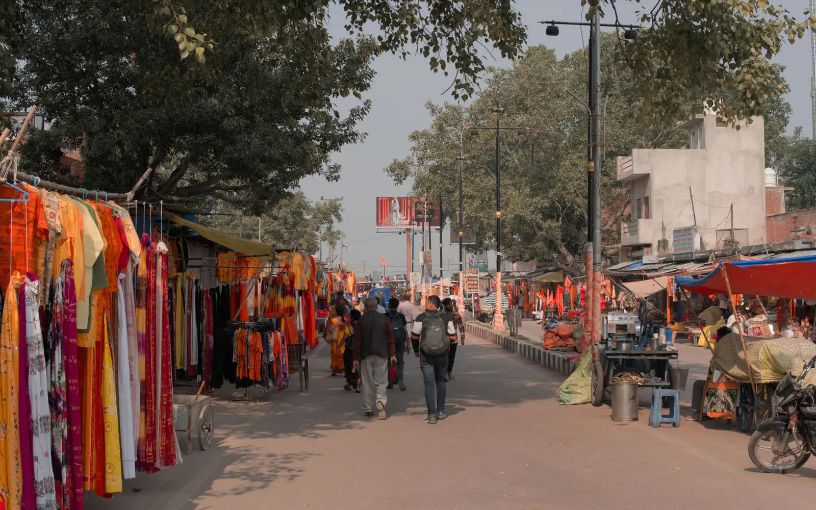 A street market lined with stalls and shoppers in an Indian town