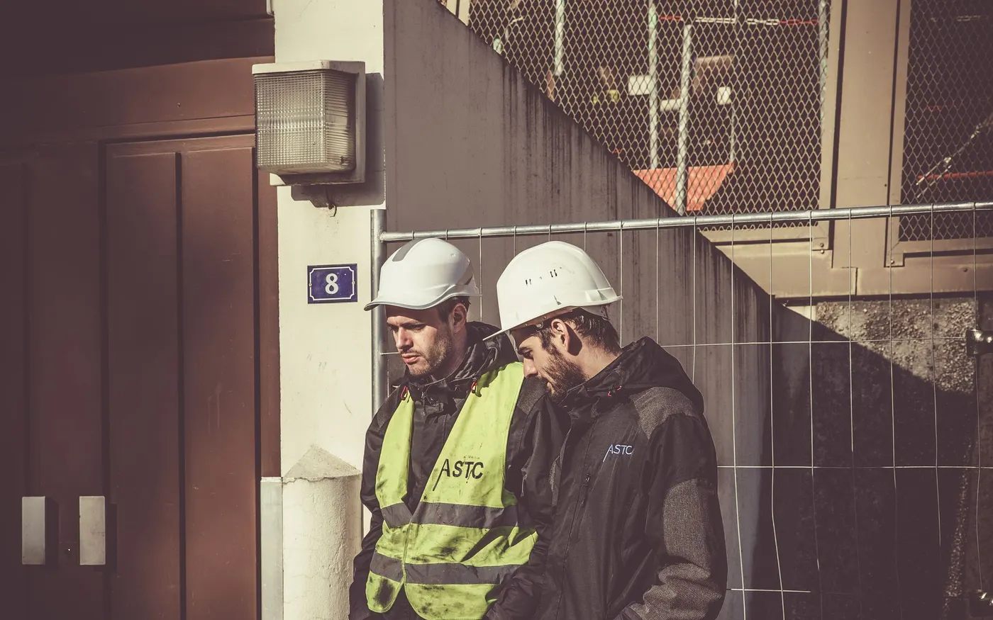 Two construction workers in safety gear on site