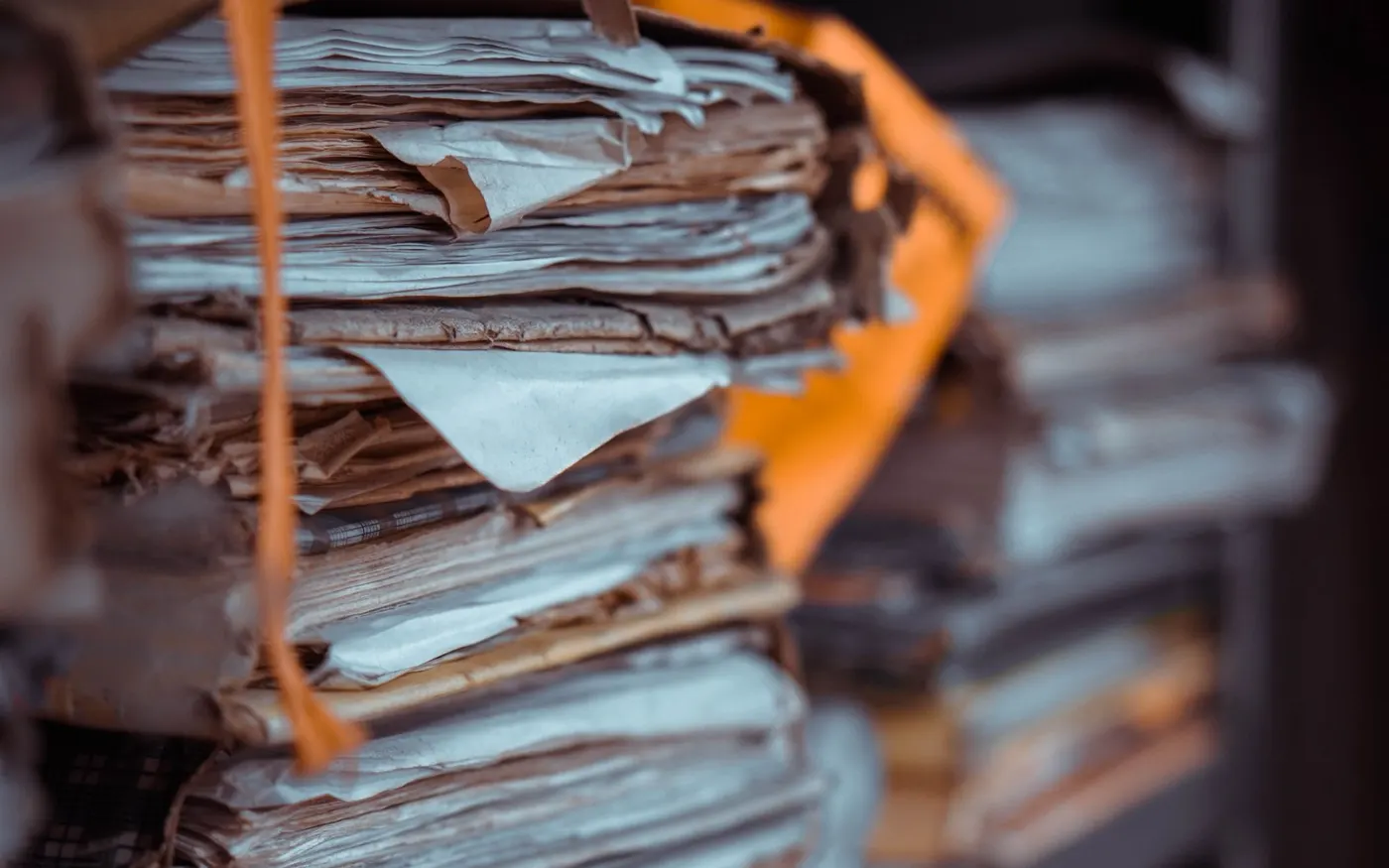 Stacked files and documents filling shelves
