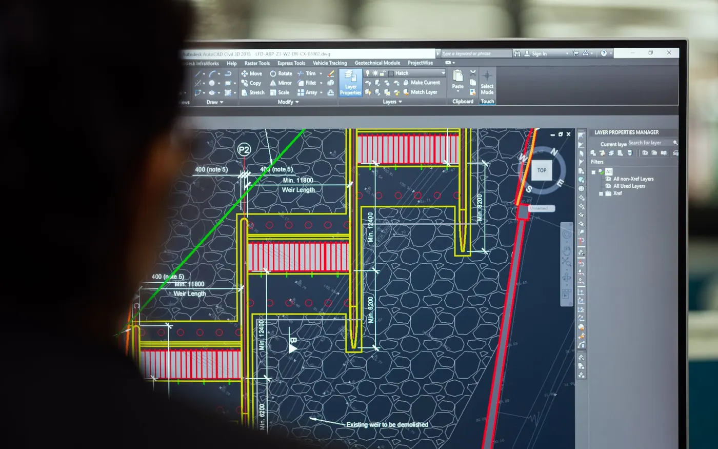 A civil engineer working on a design in CAD software