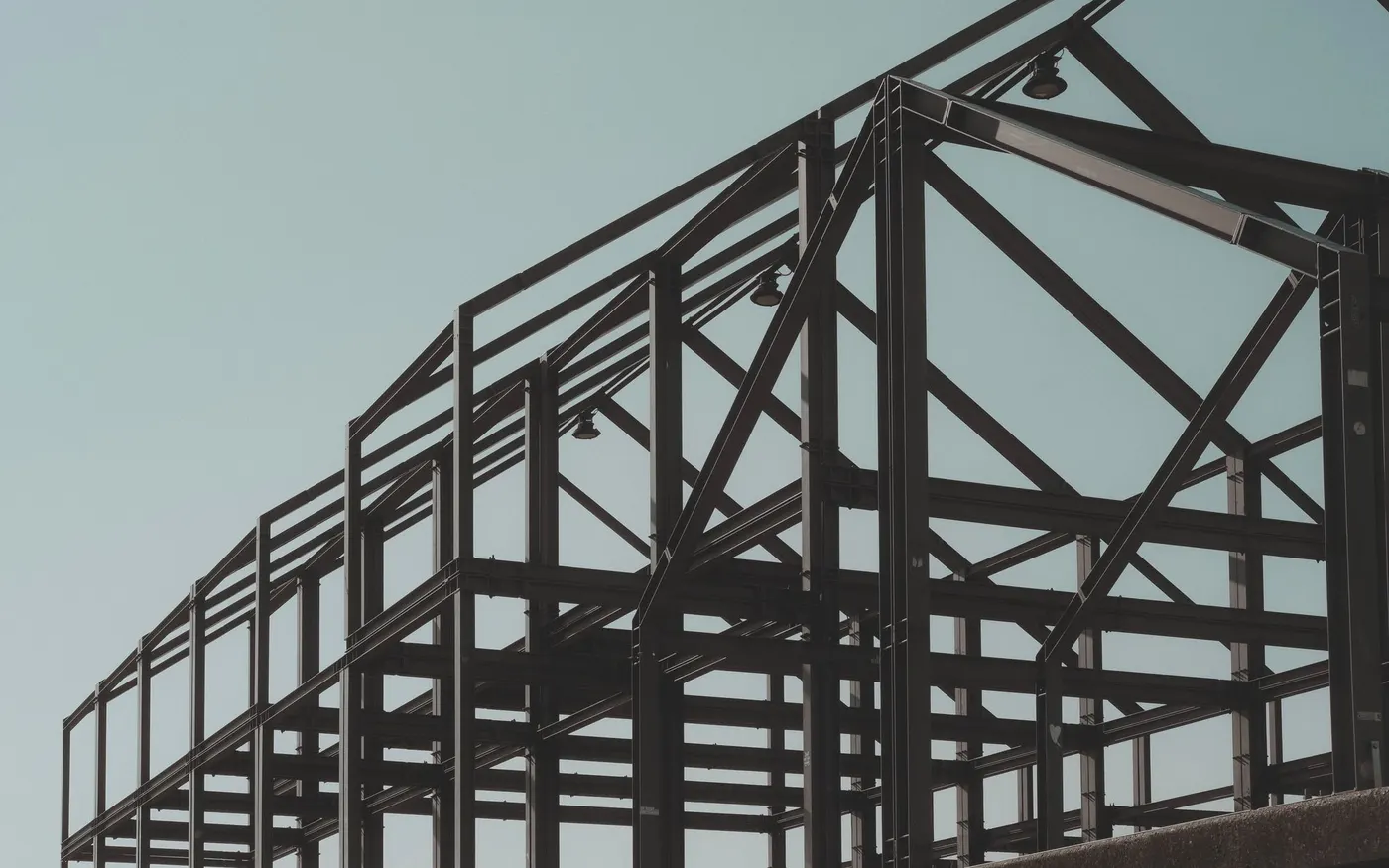 A structural steel frame standing against open sky