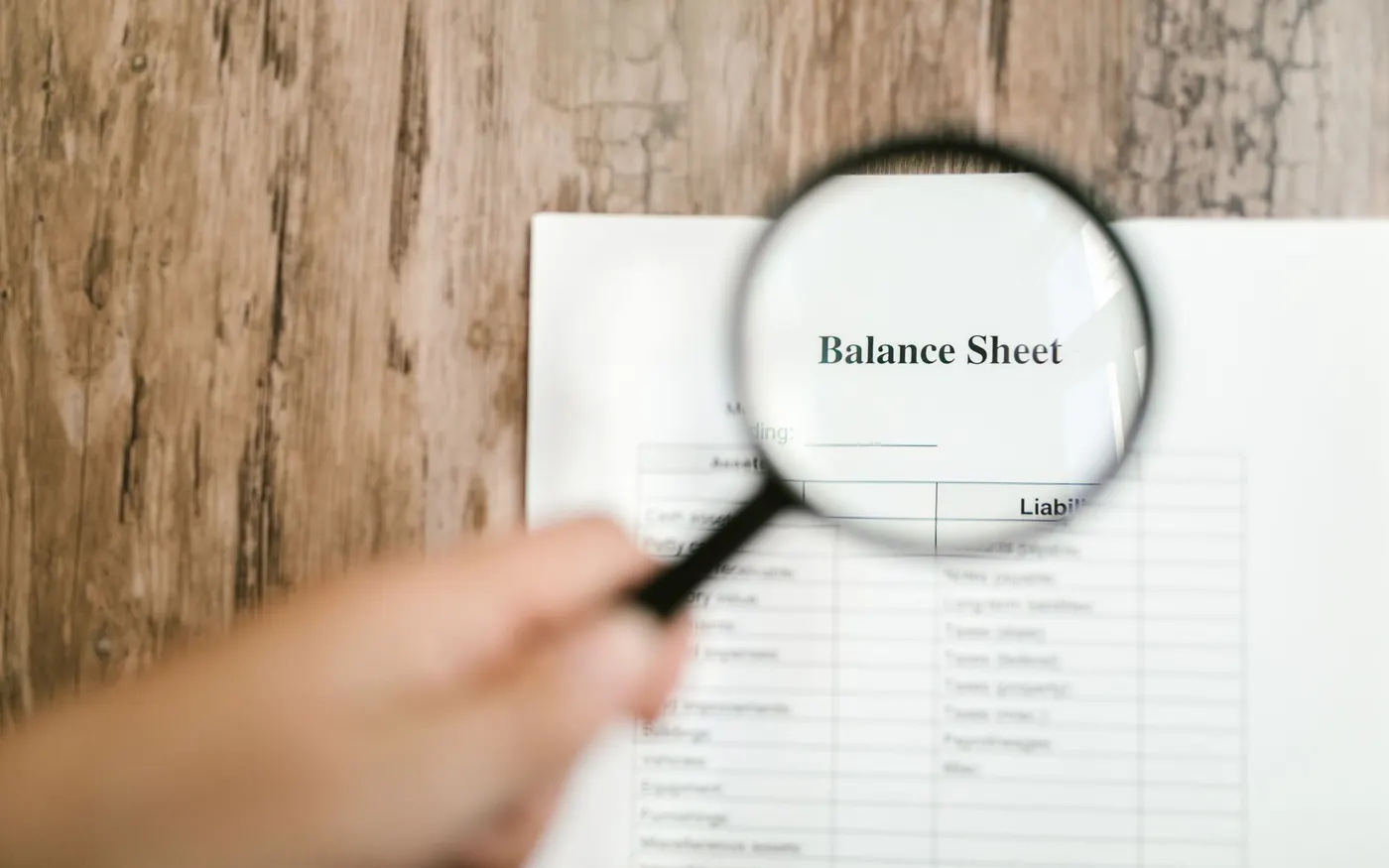 A balance sheet examined under a magnifying glass